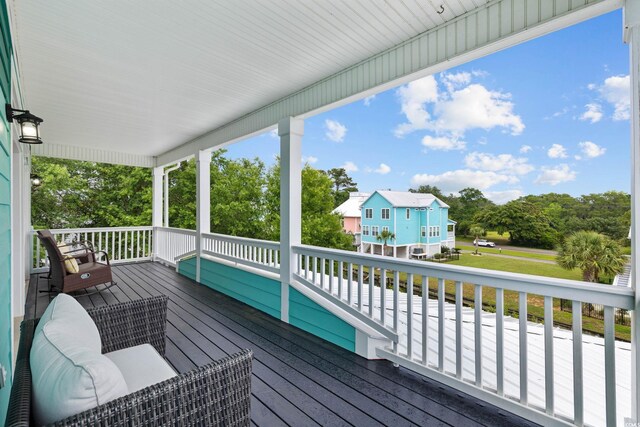 17 Trigger Fish Ln, Murrells Inlet, SC 29576 - wooden porch featuring view of wooded area