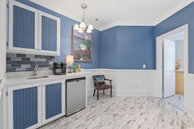17 Trigger Fish Ln, Murrells Inlet, SC 29576 - kitchen with a sink, a chandelier, light countertops, light wood-style floors, and a wainscoted wall