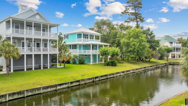 17 Trigger Fish Ln, Murrells Inlet, SC 29576 - back of property featuring a water view, a balcony, a sunroom, and a lawn