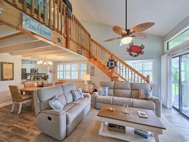 323 Wendover Ct Unit 10-A, Myrtle Beach, SC 29572 - living room featuring a chandelier, wood finished floors, stairs, plenty of natural light, and high vaulted ceiling