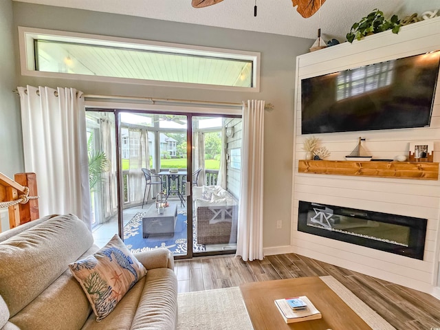 323 Wendover Ct Unit 10-A, Myrtle Beach, SC 29572 - living room with a glass covered fireplace, wood finished floors, and a ceiling fan