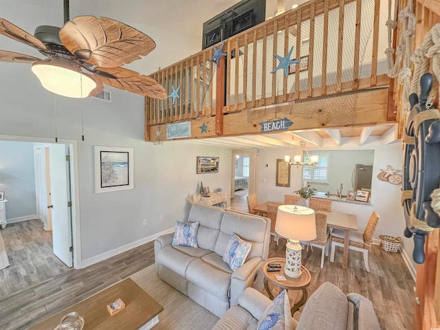 323 Wendover Ct Unit 10-A, Myrtle Beach, SC 29572 - living room featuring wood finished floors, a towering ceiling, a chandelier, and a ceiling fan