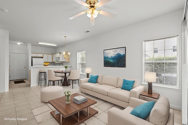 1302 River Oak Dr Unit 4B, Myrtle Beach, SC 29579 - living area with healthy amount of natural light, light tile patterned floors, ceiling fan, and baseboards