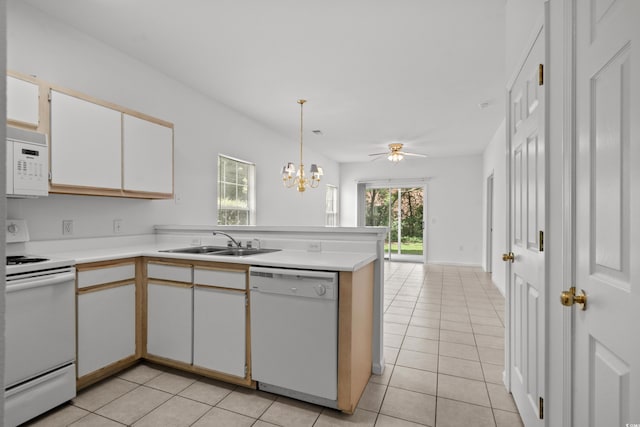 1302 River Oak Dr Unit 4B, Myrtle Beach, SC 29579 - kitchen with white appliances, a sink, a peninsula, light tile patterned flooring, and light countertops