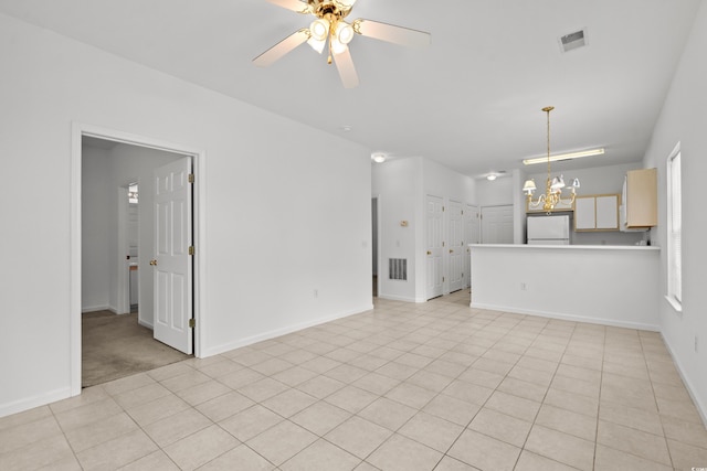 1302 River Oak Dr Unit 4B, Myrtle Beach, SC 29579 - unfurnished living room with a chandelier, ceiling fan, baseboards, and light tile patterned floors
