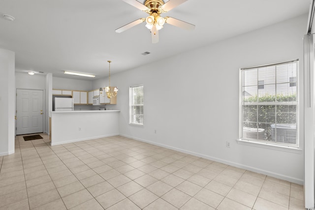1302 River Oak Dr Unit 4B, Myrtle Beach, SC 29579 - unfurnished living room featuring a ceiling fan, baseboards, a chandelier, and light tile patterned floors