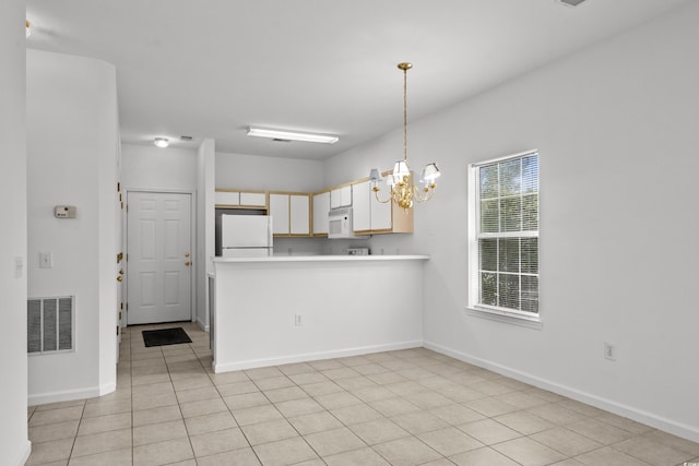 1302 River Oak Dr Unit 4B, Myrtle Beach, SC 29579 - kitchen with white appliances, a chandelier, light countertops, a peninsula, and pendant lighting