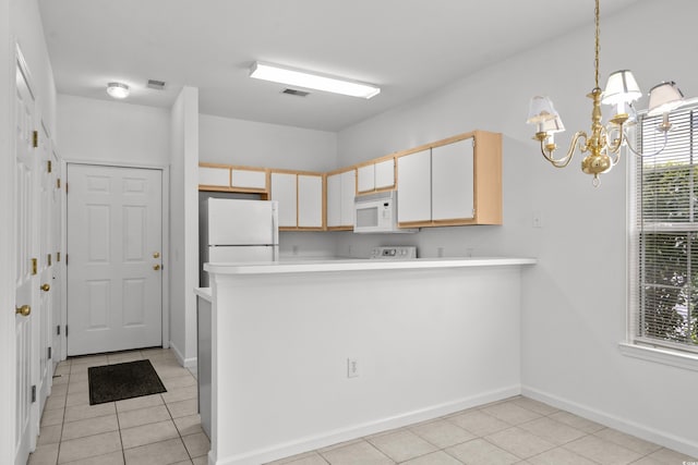 1302 River Oak Dr Unit 4B, Myrtle Beach, SC 29579 - kitchen featuring white appliances, light tile patterned floors, a chandelier, light countertops, and a peninsula