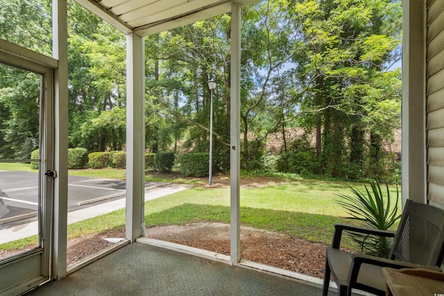 1302 River Oak Dr Unit 4B, Myrtle Beach, SC 29579 - unfurnished sunroom featuring view of wooded area