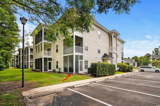 1302 River Oak Dr Unit 4B, Myrtle Beach, SC 29579 - view of building exterior with uncovered parking and cooling unit