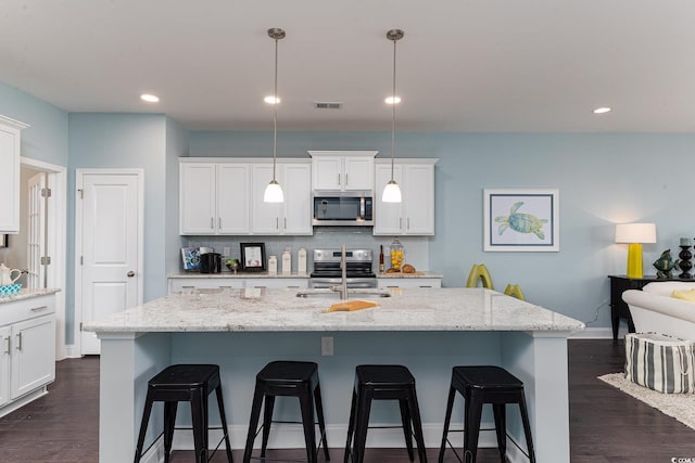 170 Bantry Ln, Conway, SC 29526 - kitchen featuring appliances with stainless steel finishes, a kitchen breakfast bar, tasteful backsplash, white cabinetry, and recessed lighting