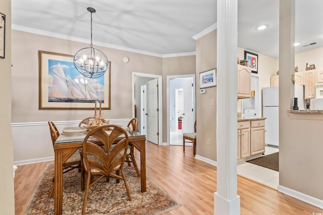 405 Pipers Ln Unit 405, Myrtle Beach, SC 29575 - dining space featuring light wood finished floors, a chandelier, crown molding, and baseboards