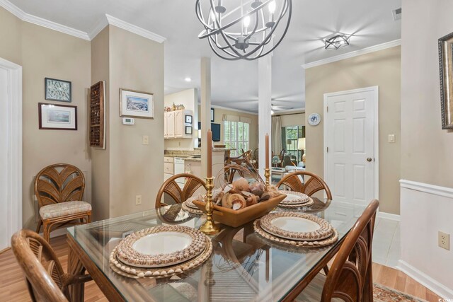 405 Pipers Ln Unit 405, Myrtle Beach, SC 29575 - dining space featuring a chandelier, crown molding, light wood-style floors, and baseboards