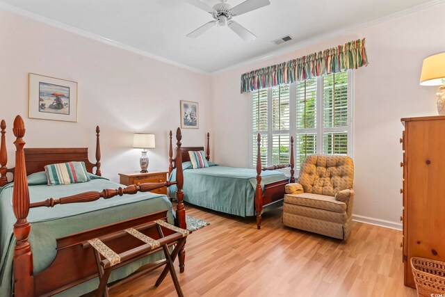 405 Pipers Ln Unit 405, Myrtle Beach, SC 29575 - bedroom with crown molding, light wood-style flooring, ceiling fan, and baseboards