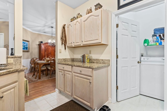 405 Pipers Ln Unit 405, Myrtle Beach, SC 29575 - kitchen with washer / dryer, crown molding, light stone counters, light brown cabinets, and light tile patterned flooring