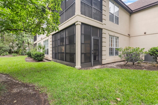405 Pipers Ln Unit 405, Myrtle Beach, SC 29575 - exterior space with a balcony, a lawn, stucco siding, and a sunroom