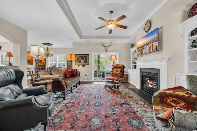 773 Wintercreeper Dr, Longs, SC 29568 - living area featuring ceiling fan, a glass covered fireplace, crown molding, a chandelier, and wood finished floors