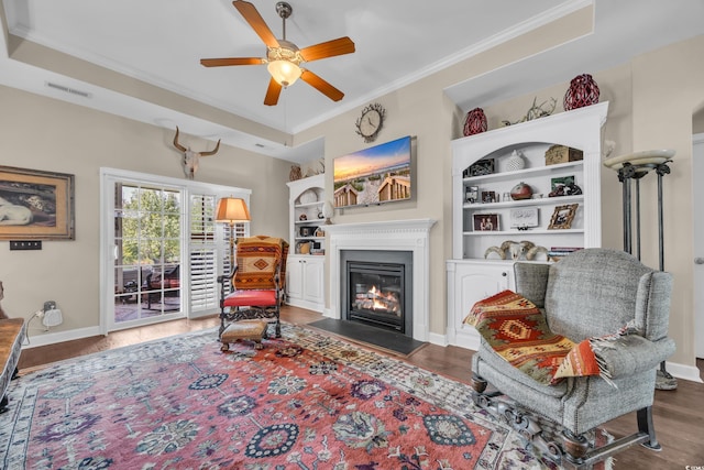773 Wintercreeper Dr, Longs, SC 29568 - living area with ornamental molding, a fireplace with flush hearth, wood finished floors, and a ceiling fan