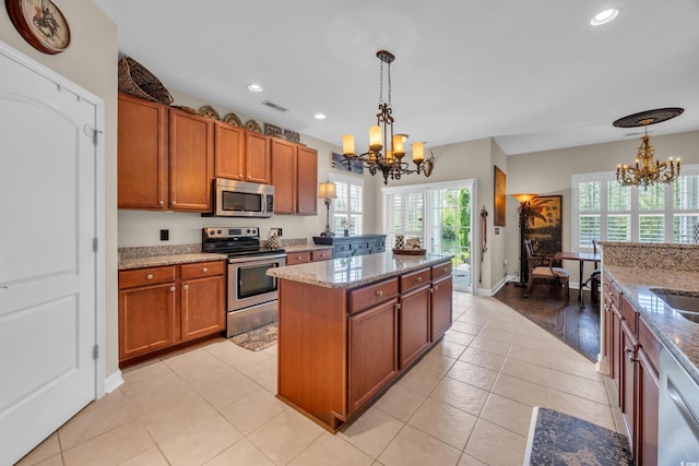773 Wintercreeper Dr, Longs, SC 29568 - kitchen featuring appliances with stainless steel finishes, a chandelier, brown cabinets, a kitchen island, and recessed lighting
