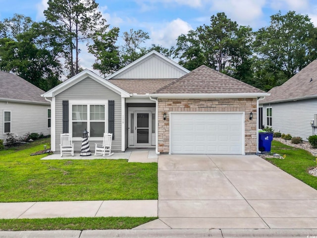 1178 Pyxie Moss Dr, Little River, SC 29566 - view of front facade with a front yard, an attached garage, concrete driveway, a shingled roof, and stone siding
