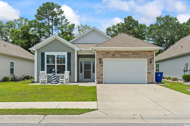 1178 Pyxie Moss Dr, Little River, SC 29566 - view of front of house featuring a front lawn, a garage, concrete driveway, and stone siding
