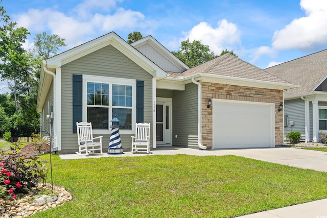 1178 Pyxie Moss Dr, Little River, SC 29566 - view of front of property with a front lawn, a garage, driveway, stone siding, and board and batten siding