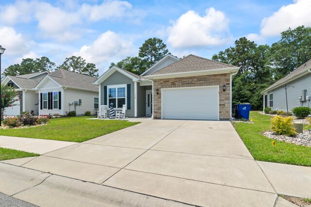 1178 Pyxie Moss Dr, Little River, SC 29566 - single story home with an attached garage, a front yard, stone siding, and driveway