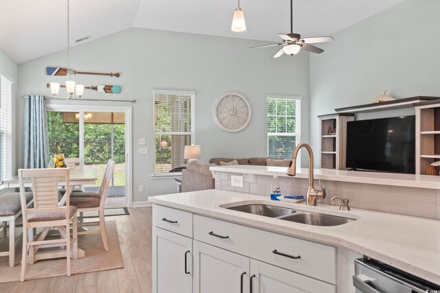 1178 Pyxie Moss Dr, Little River, SC 29566 - kitchen with open floor plan, a sink, stainless steel dishwasher, hanging light fixtures, and light stone countertops