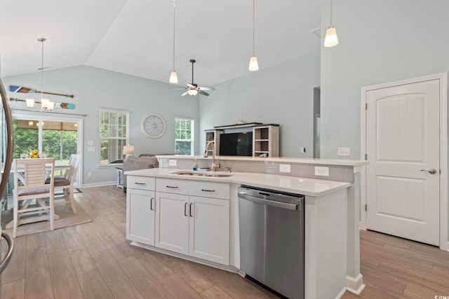 1178 Pyxie Moss Dr, Little River, SC 29566 - kitchen featuring stainless steel dishwasher, a sink, open floor plan, light countertops, and light wood-type flooring