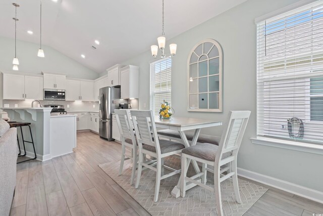 1178 Pyxie Moss Dr, Little River, SC 29566 - dining area with light wood finished floors, vaulted ceiling, a chandelier, recessed lighting, and baseboards