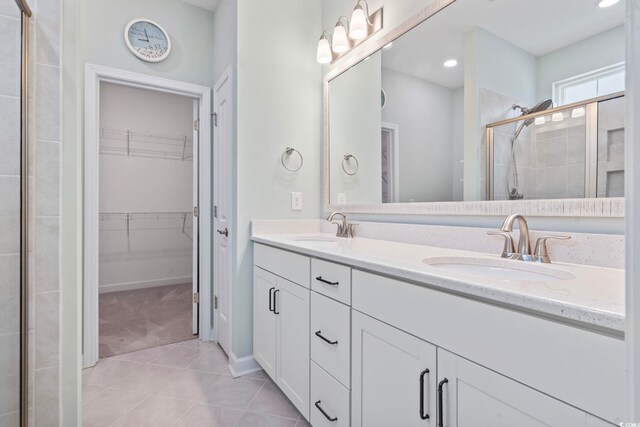 1178 Pyxie Moss Dr, Little River, SC 29566 - full bathroom with tile patterned floors, a shower stall, double vanity, a walk in closet, and recessed lighting