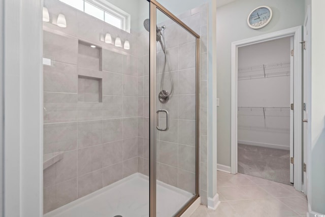 1178 Pyxie Moss Dr, Little River, SC 29566 - bathroom featuring a shower stall, a spacious closet, tile patterned floors, and baseboards