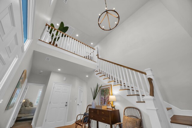 573 S Dunes Dr, Pawleys Island, SC 29585 - foyer featuring a towering ceiling, stairway, a chandelier, and recessed lighting