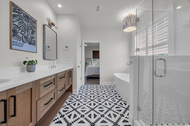 573 S Dunes Dr, Pawleys Island, SC 29585 - full bath with double vanity, connected bathroom, a shower stall, and a freestanding tub