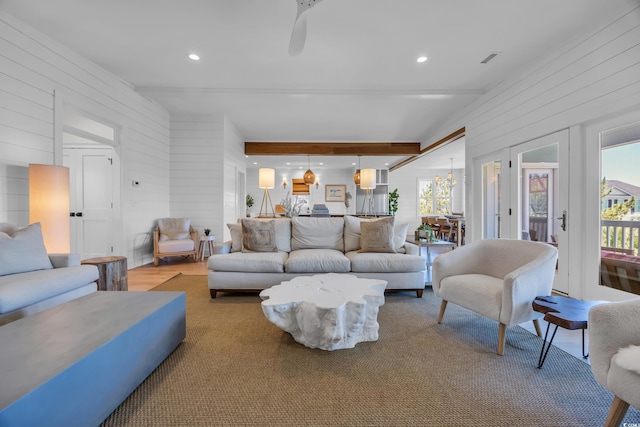 573 S Dunes Dr, Pawleys Island, SC 29585 - living room featuring wood walls, beamed ceiling, and recessed lighting