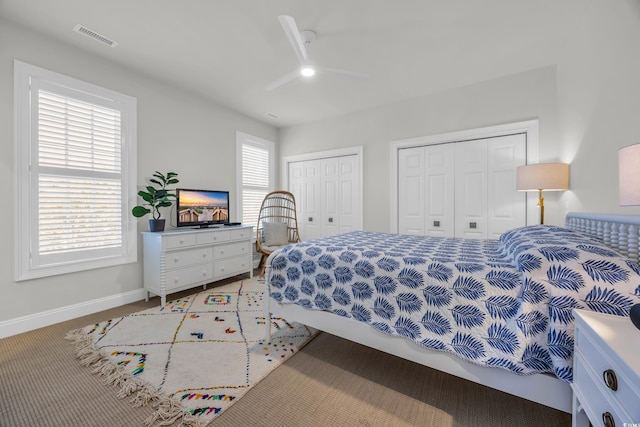 573 S Dunes Dr, Pawleys Island, SC 29585 - bedroom with multiple closets, light carpet, and ceiling fan