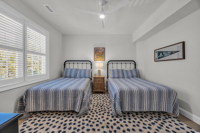 573 S Dunes Dr, Pawleys Island, SC 29585 - bedroom featuring multiple windows and ceiling fan