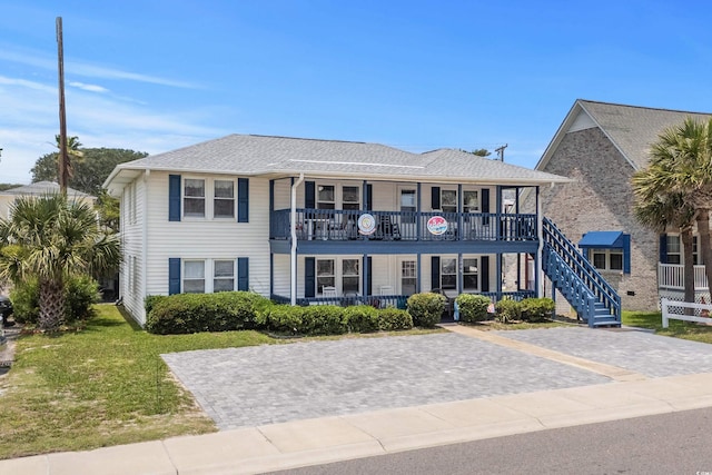 2006 S Ocean Blvd, North Myrtle Beach, SC 29582 - view of front of property with covered porch, a balcony, and a front yard