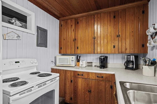 2006 S Ocean Blvd, North Myrtle Beach, SC 29582 - kitchen featuring white appliances, wood ceiling, electric panel, brown cabinetry, and light countertops