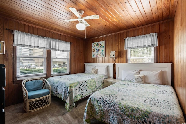 2006 S Ocean Blvd, North Myrtle Beach, SC 29582 - carpeted bedroom featuring wooden ceiling, wood walls, and ceiling fan