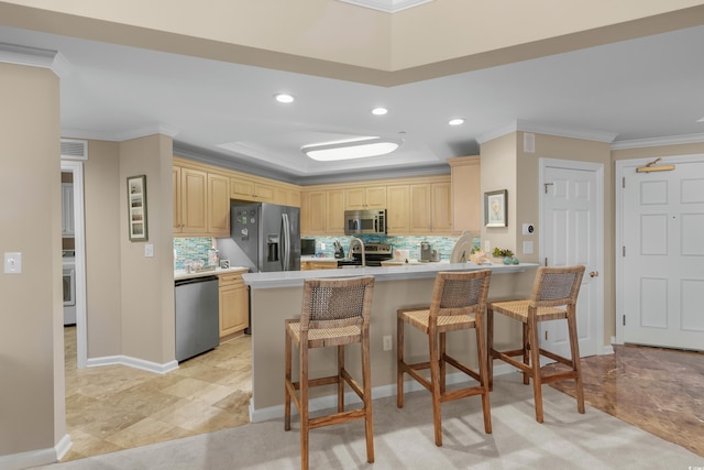 8500 Margate Cir Unit 505, Myrtle Beach, SC 29572 - kitchen featuring stainless steel appliances, a peninsula, crown molding, recessed lighting, and decorative backsplash