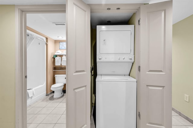 2301 S Ocean Blvd Unit 1405, North Myrtle Beach, SC 29582 - laundry area with estacked washer and dryer, light tile patterned floors, and baseboards
