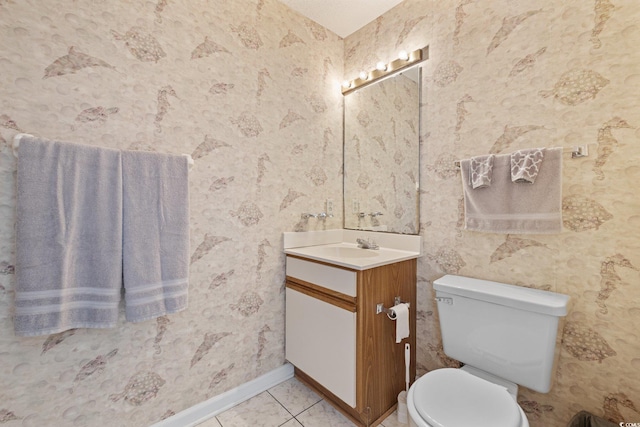 1890 Colony Dr Unit 17L, Surfside Beach, SC 29575 - bathroom featuring wallpapered walls, vanity, toilet, baseboards, and tile patterned floors