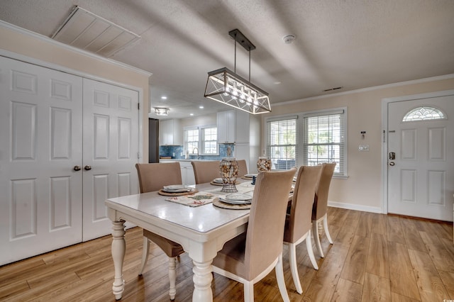 321 53rd Ave N, North Myrtle Beach, SC 29582 - dining room featuring light wood finished floors, ornamental molding, a chandelier, recessed lighting, and a textured ceiling