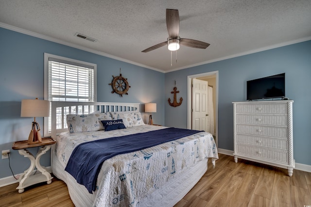 321 53rd Ave N, North Myrtle Beach, SC 29582 - bedroom with crown molding, wood finished floors, a textured ceiling, and a ceiling fan