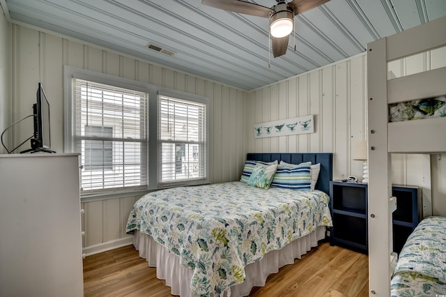 321 53rd Ave N, North Myrtle Beach, SC 29582 - bedroom with light wood-type flooring, a decorative wall, and a ceiling fan