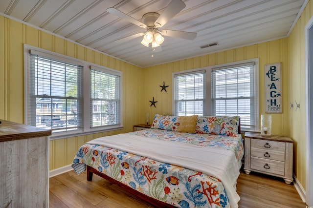 321 53rd Ave N, North Myrtle Beach, SC 29582 - bedroom with multiple windows, light wood-style floors, ornamental molding, and a ceiling fan