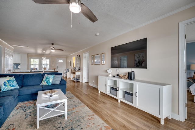 321 53rd Ave N, North Myrtle Beach, SC 29582 - living area featuring ceiling fan, a textured ceiling, light wood-type flooring, and crown molding