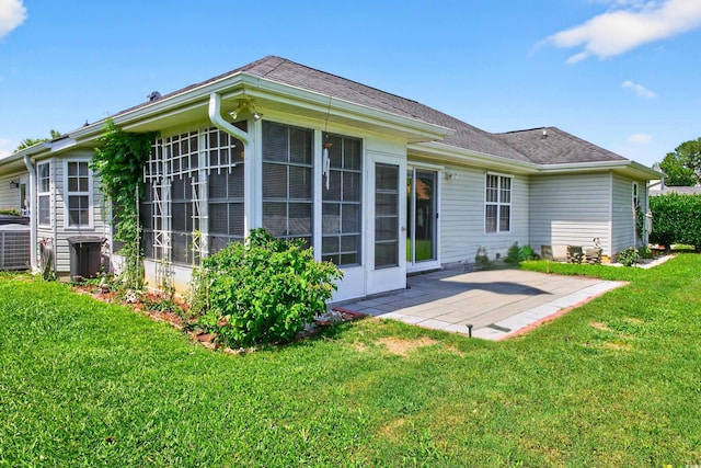 435 Seneca St NW, Calabash, NC 28467 - back of house featuring a patio area, a lawn, a sunroom, and roof with shingles
