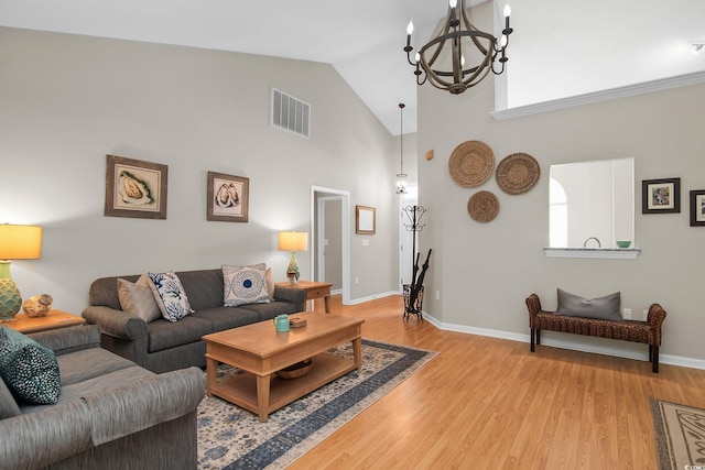 161 Patriot Ln, Pawleys Island, SC 29585 - living room featuring a chandelier, light wood-style floors, high vaulted ceiling, and plenty of natural light